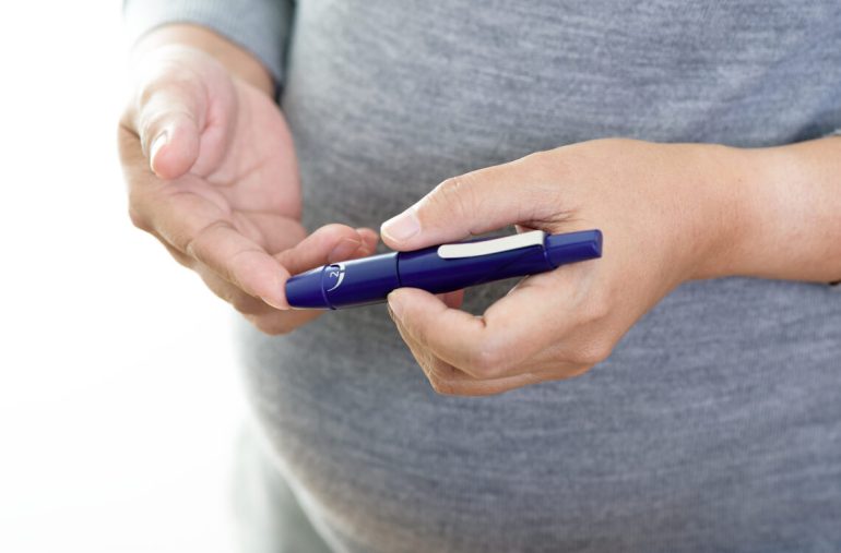 A GDM patient checking her blood sugar level