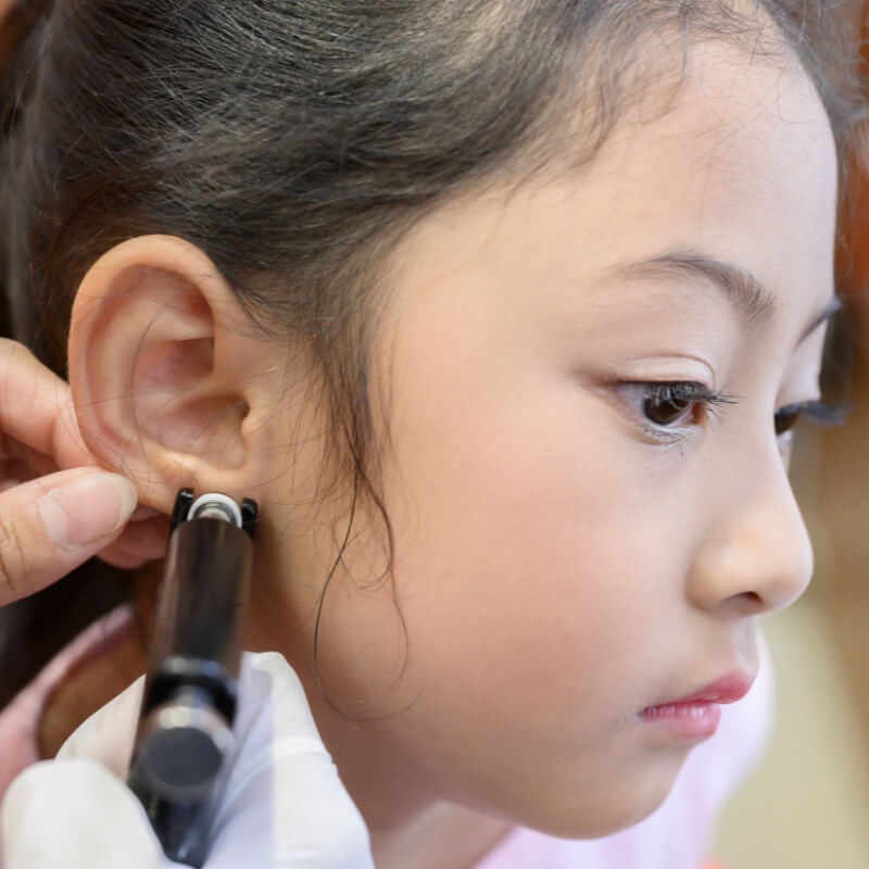 A girl getting ready for ear piercing