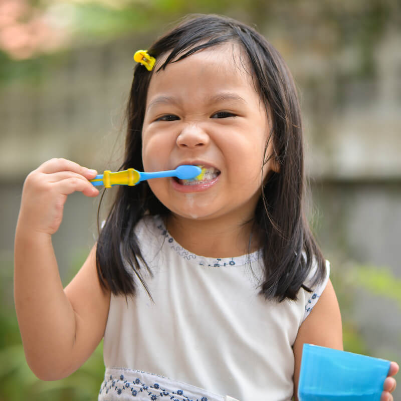 A girl brushing her teeth