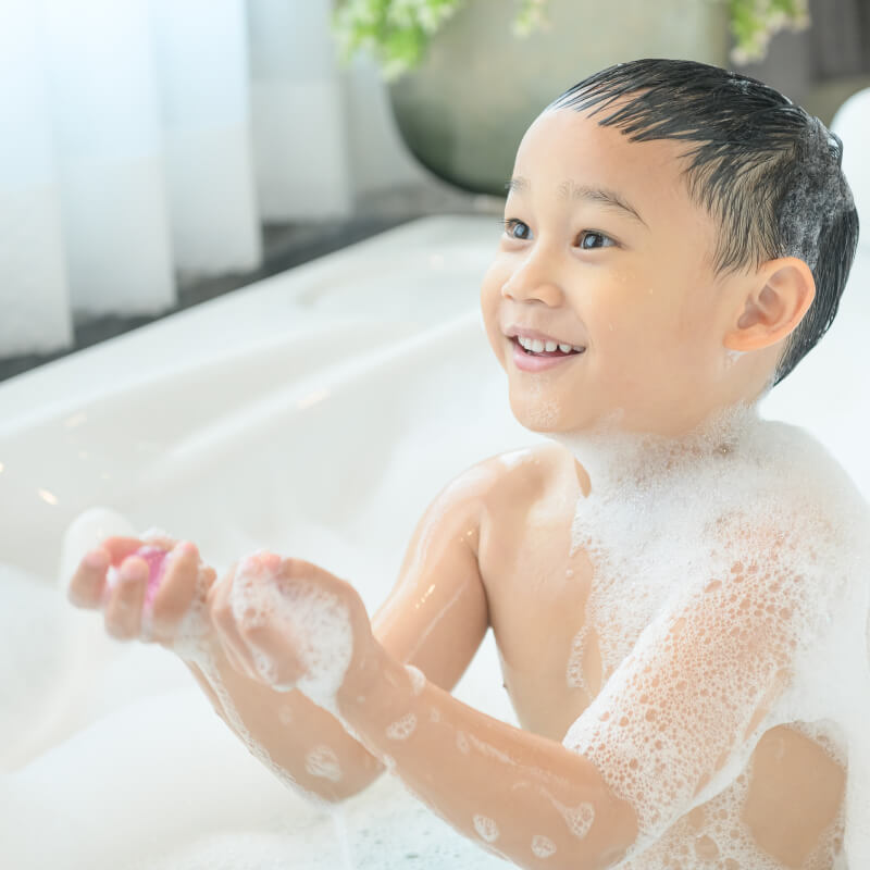 A boy taking a bath for body care