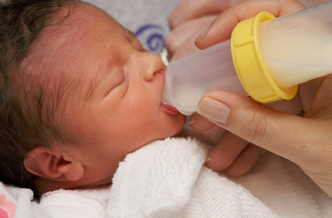 A premature baby breastfeeding through bottle