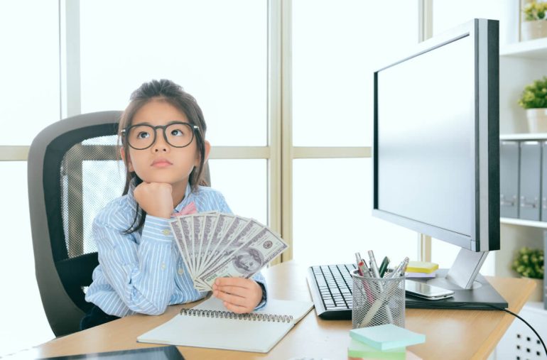 A girl holding money thinking about inflation