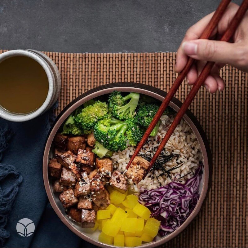 vegan rice bowl with tofu, broccoli, cabbage , radish
