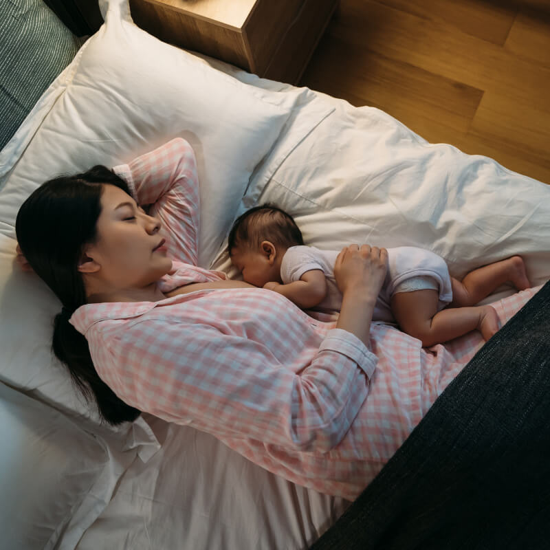 A mum breastfeeding while laying down