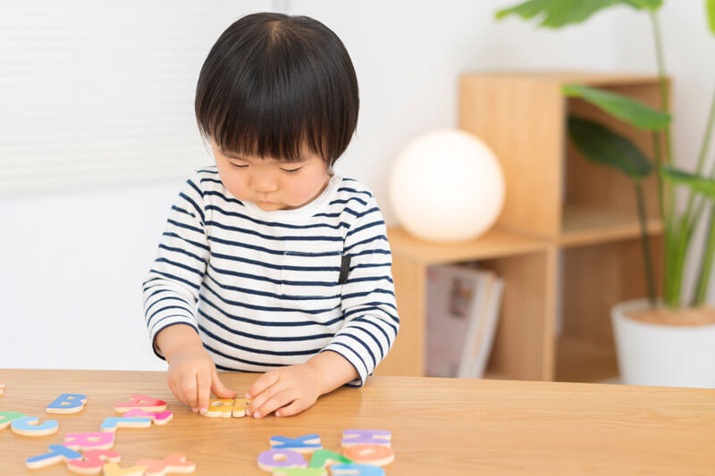 child doing puzzle