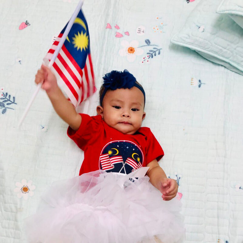 Baby girl holding a Malaysian flag