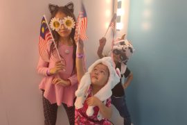 My kids posing with their flags for National Day