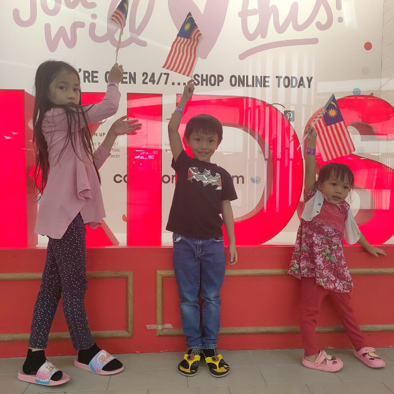 My kids posing in front of a store