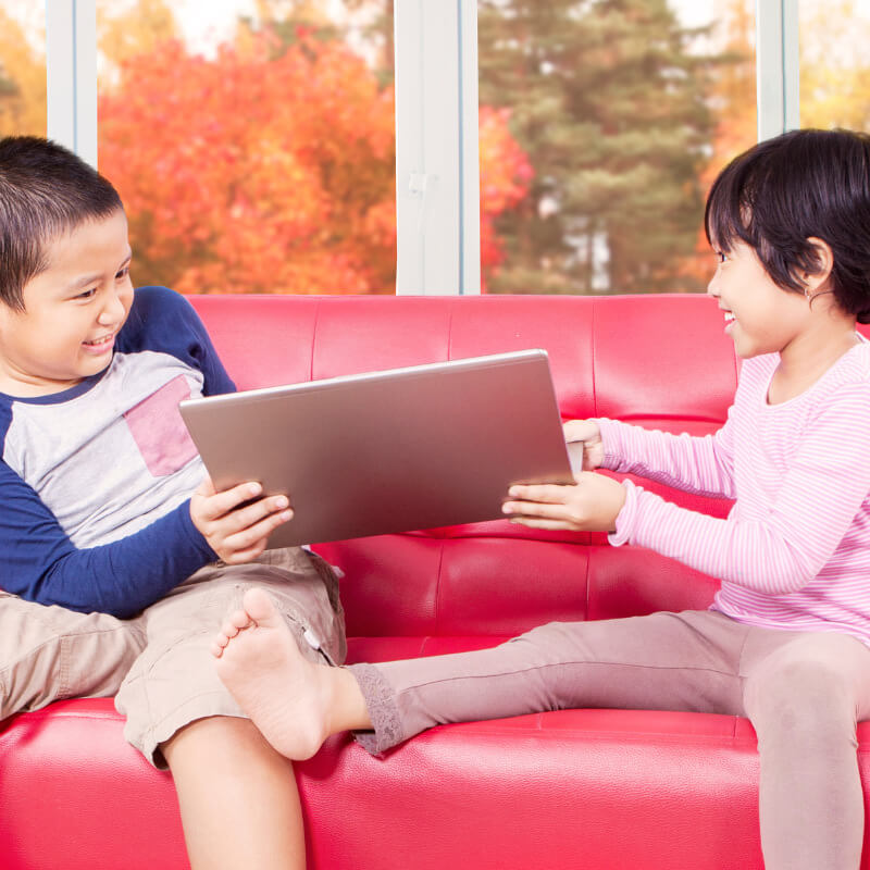 Sibling fighting for a laptop