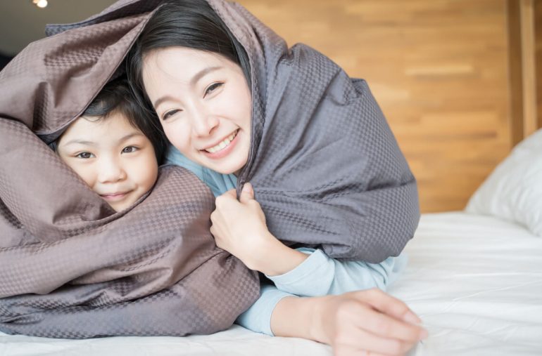 A mum relaxing with her daughter during school holiday