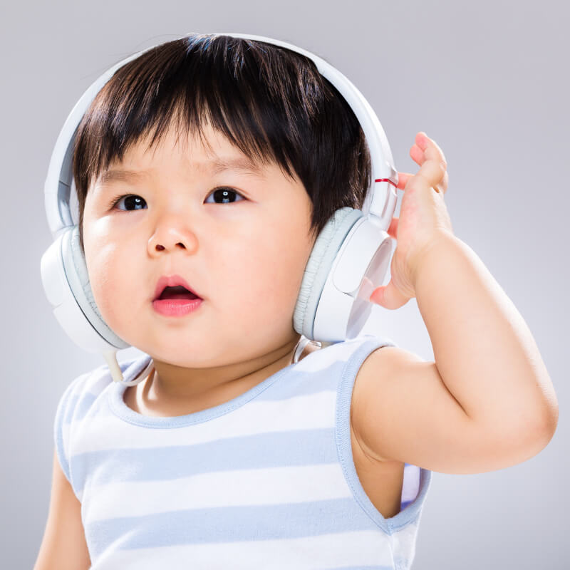 A baby covering ears using headphones