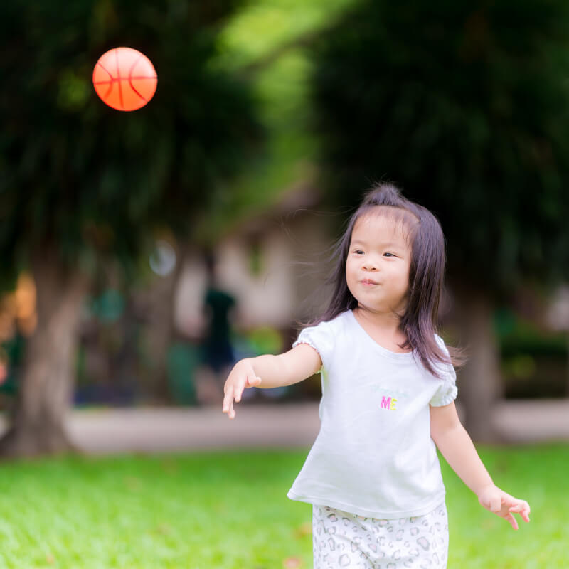 A girl playing a ball