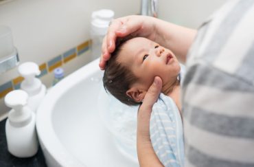 Baby taking a bath at the sink