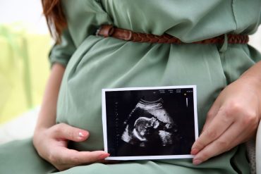 A mum holding an ultrasound scan