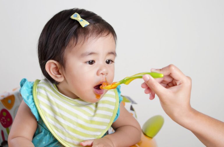 Baby eating first food