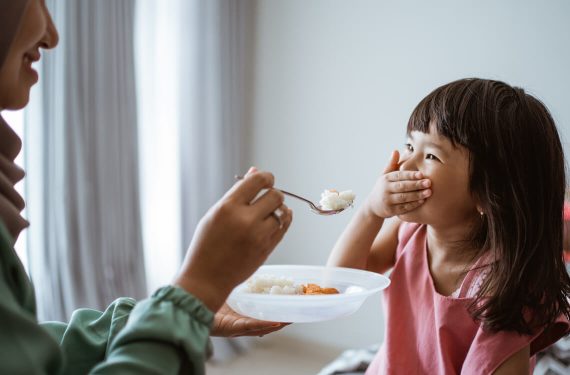 A girl refuse to eat vegetables