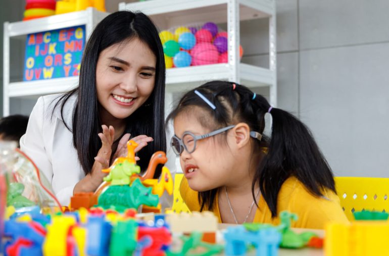Down syndrome girl with her teacher