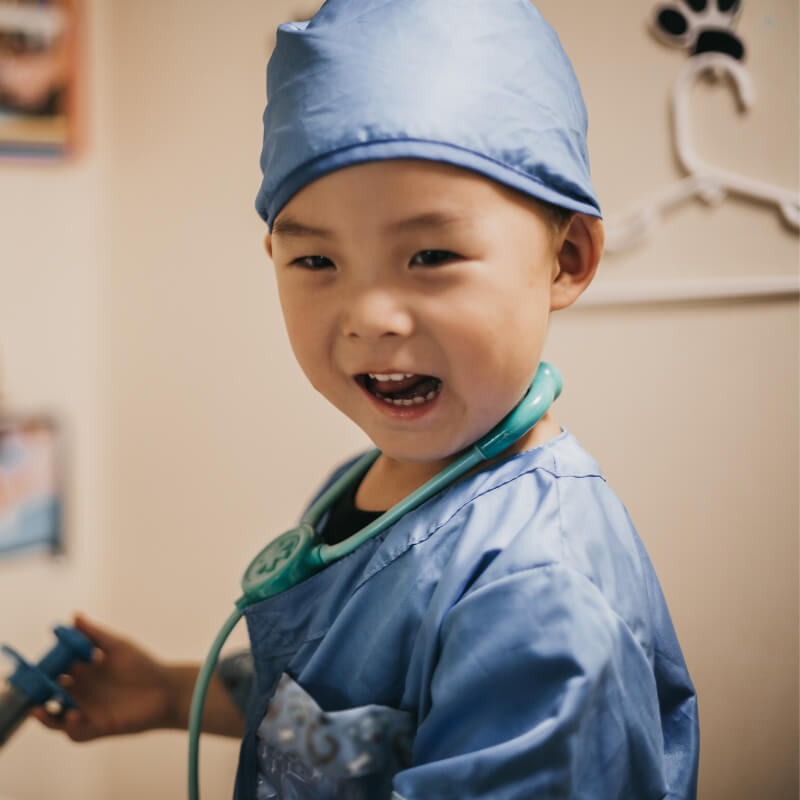 a boy pretending to be a doctor as health literacy activity