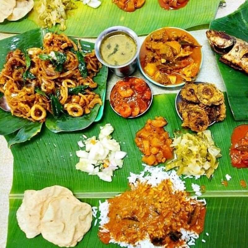 indian dishes on banana leaf seafood