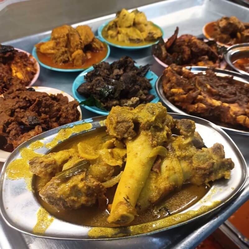 various meat curries on tray