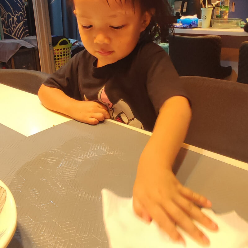A girl wiping the table