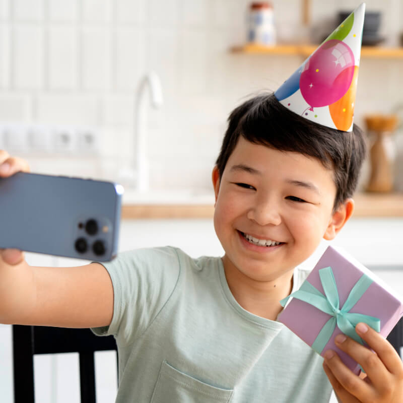 A boy taking a birthday video