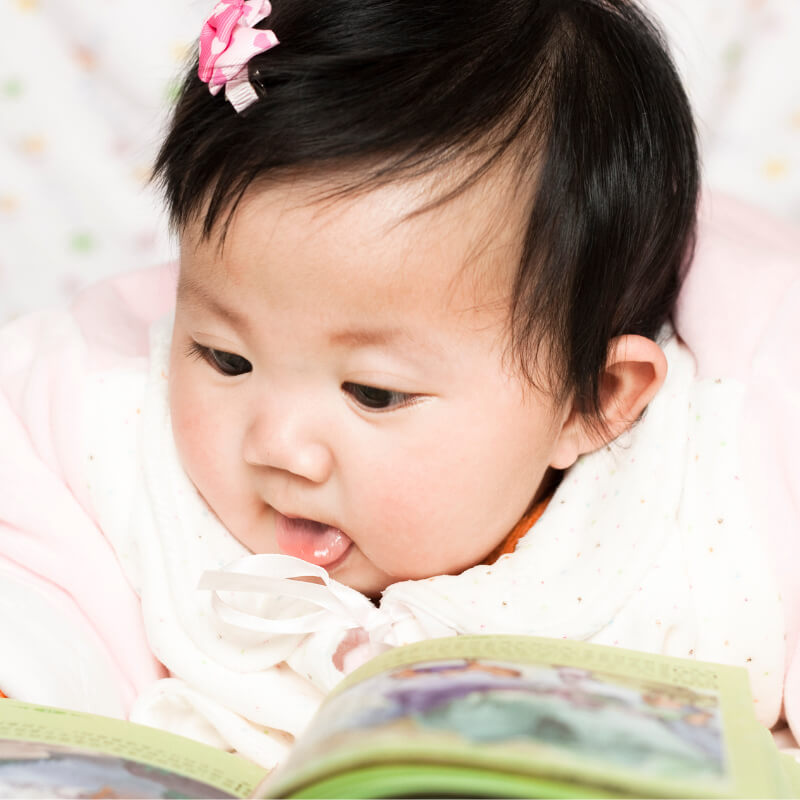 A baby reading a book