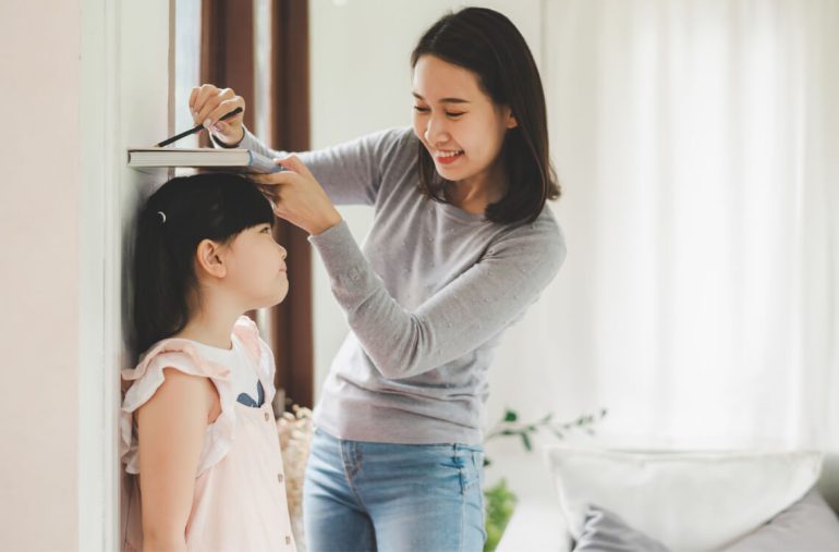 A mum checking kid's growth