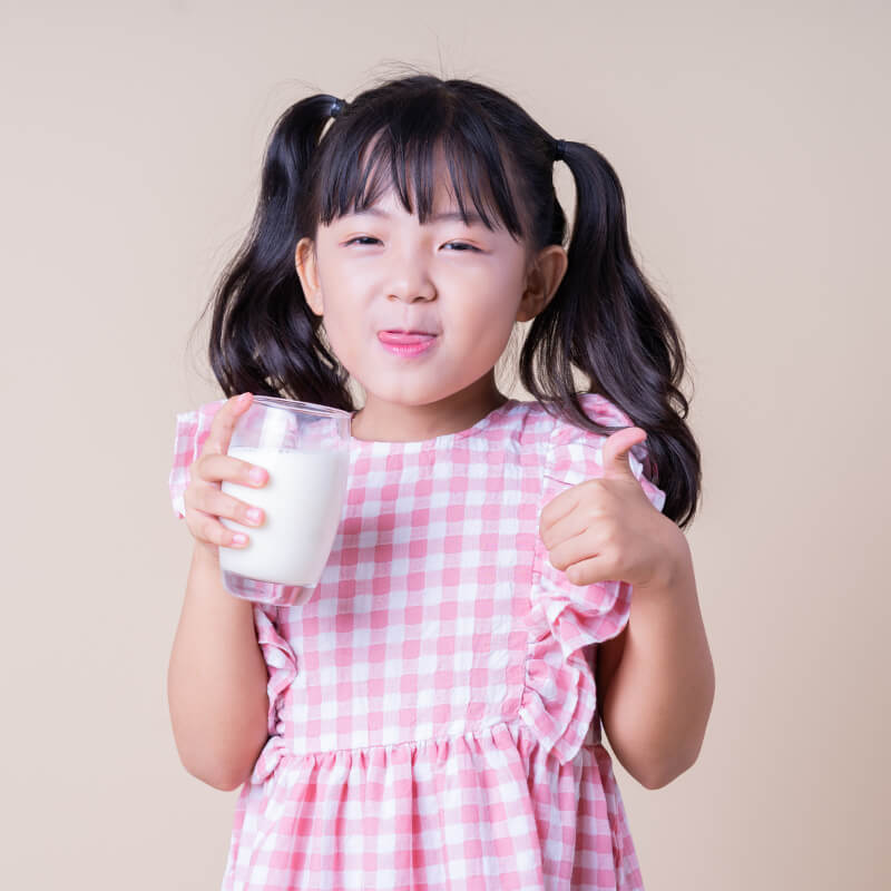 A girl drinking milk for growth