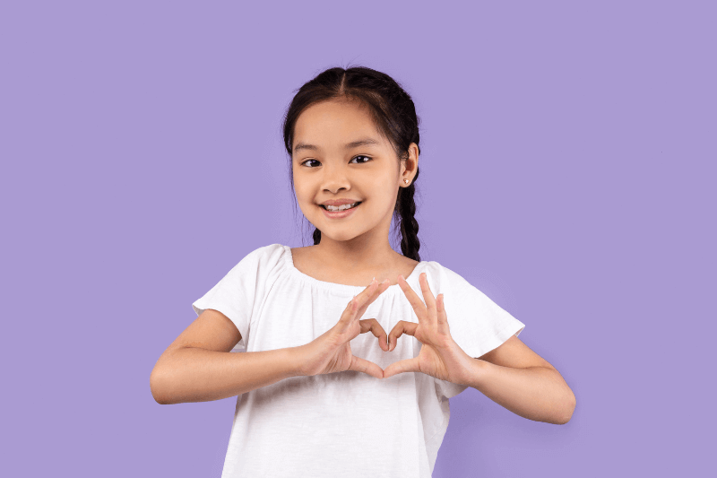 A girl making hands into heart shape