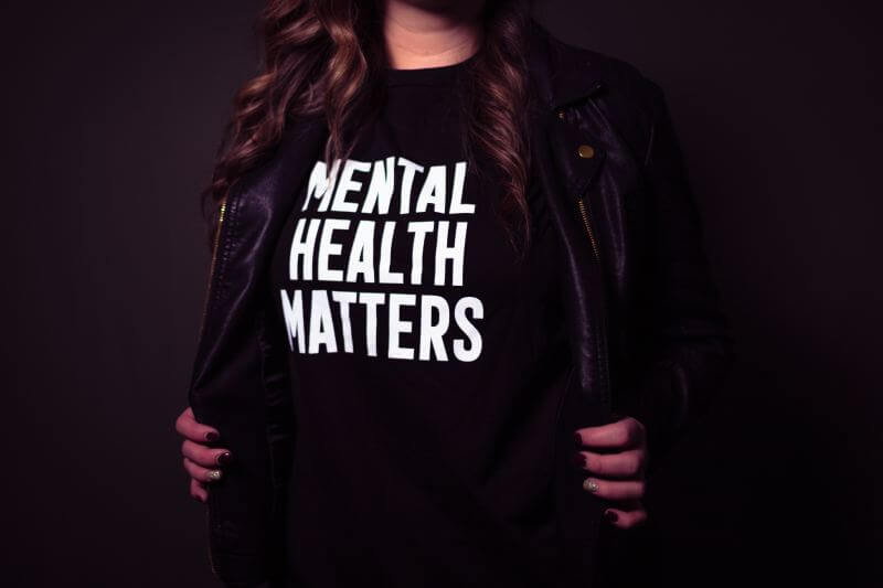 woman with black t shirt with mental health message