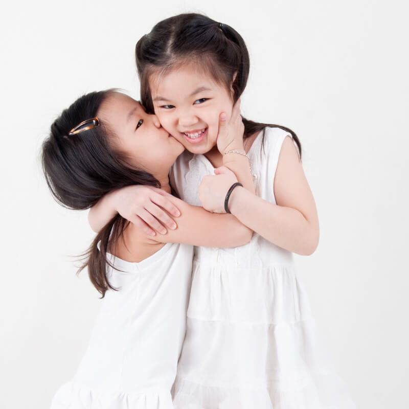 a girl kissing her sister