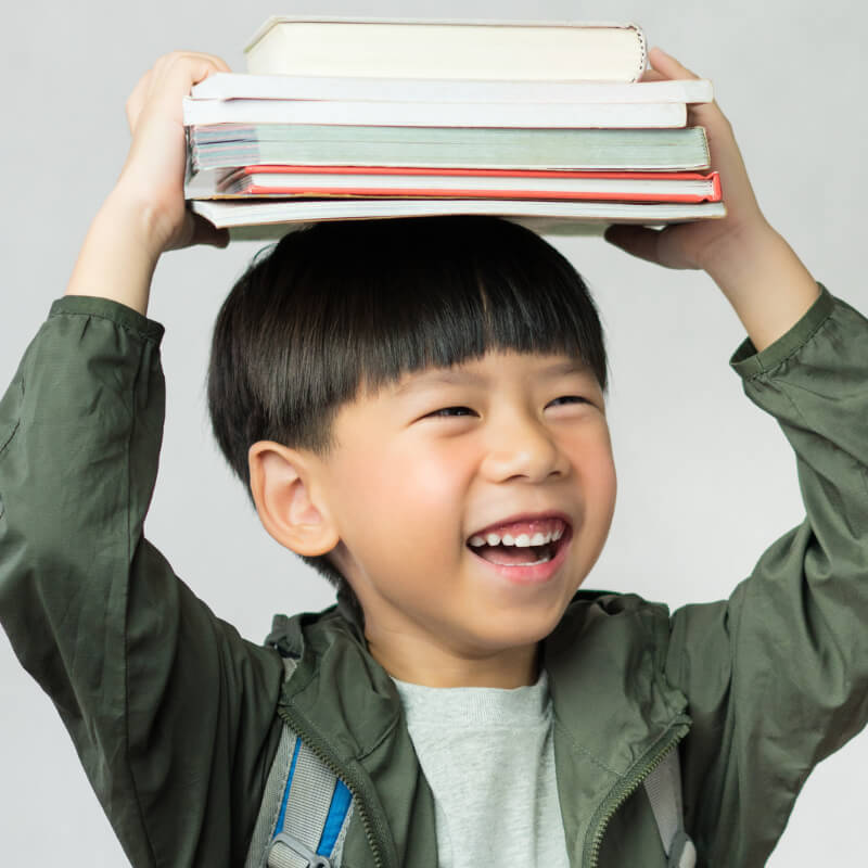 a boy carrying books