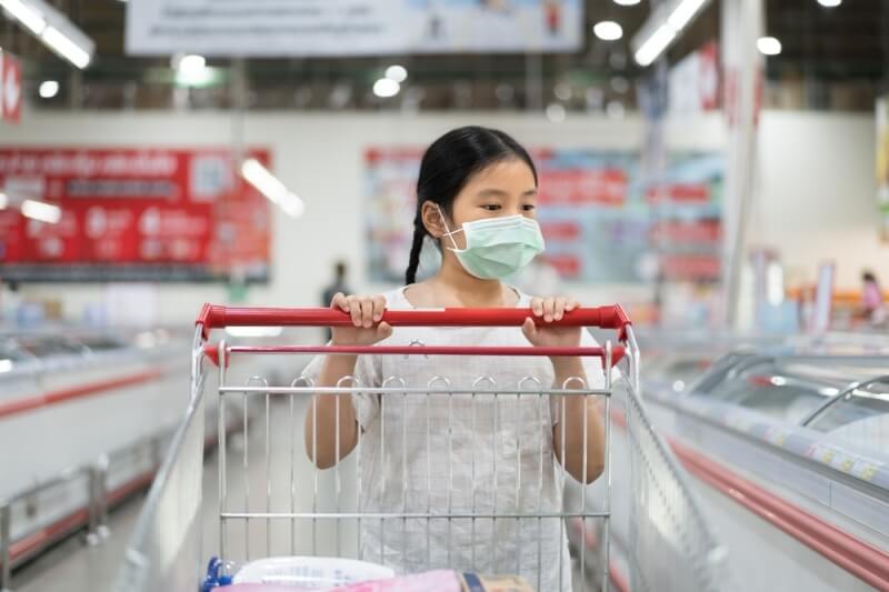 girl pushing shopping cart