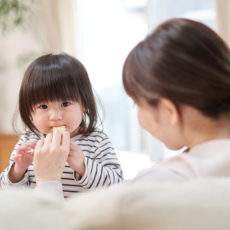 a mum feeding snack to her picky eater