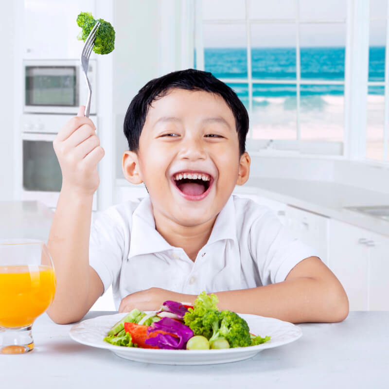 a boy happy with his veggies