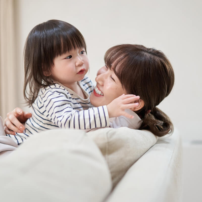 A mum cuddling her daughter