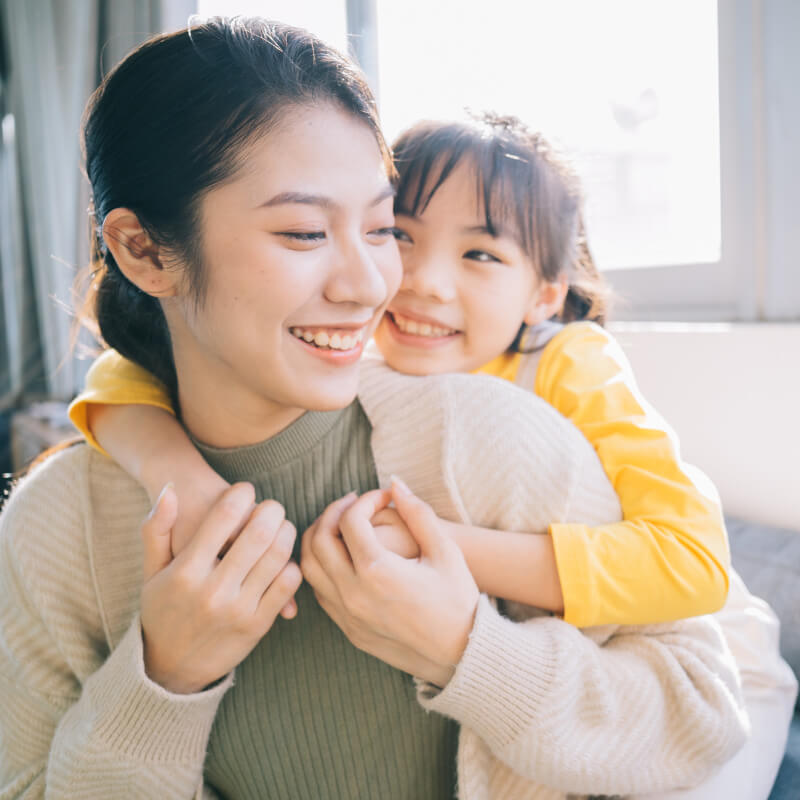 A mum hugging her daughter