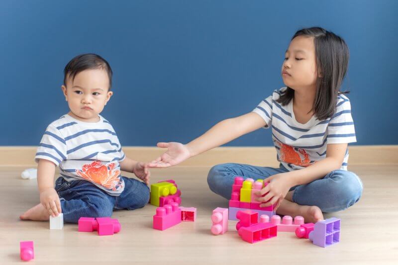 siblings playing toys life lessons