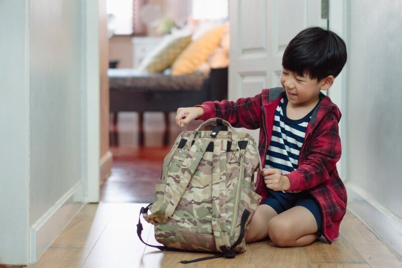 child packing his bag