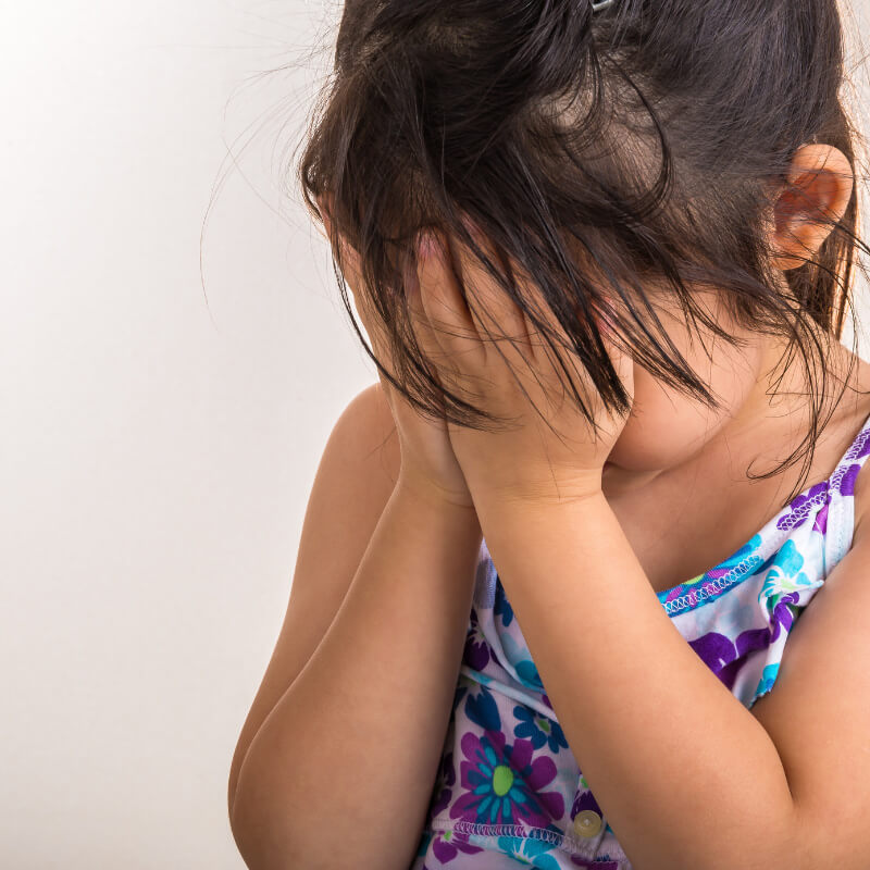 a girl playing hide and seek