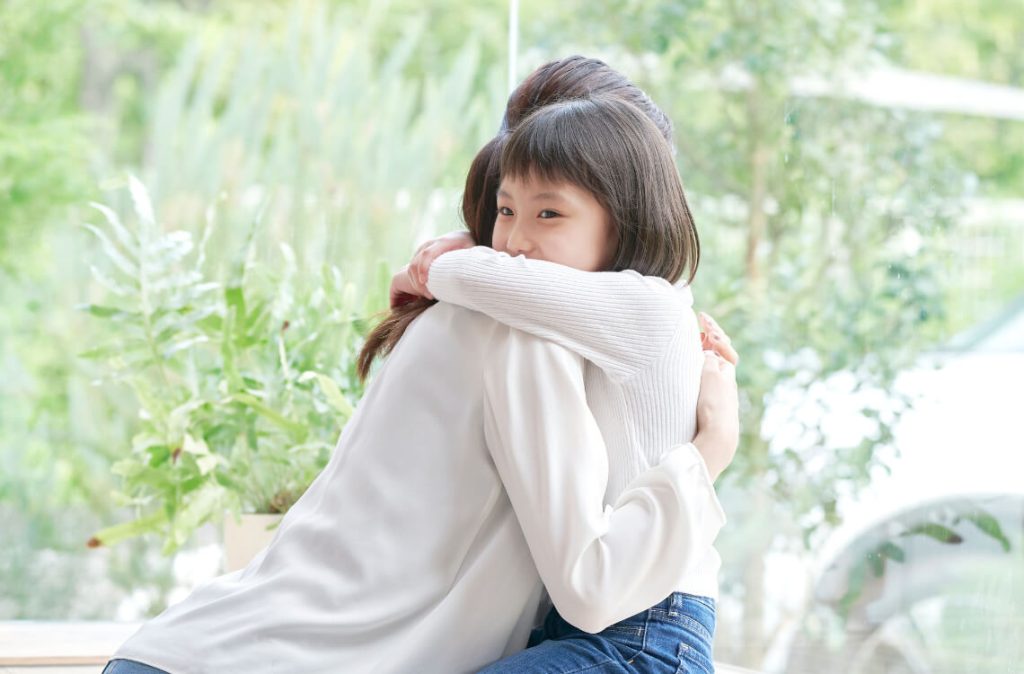 Mother and daughter hugging