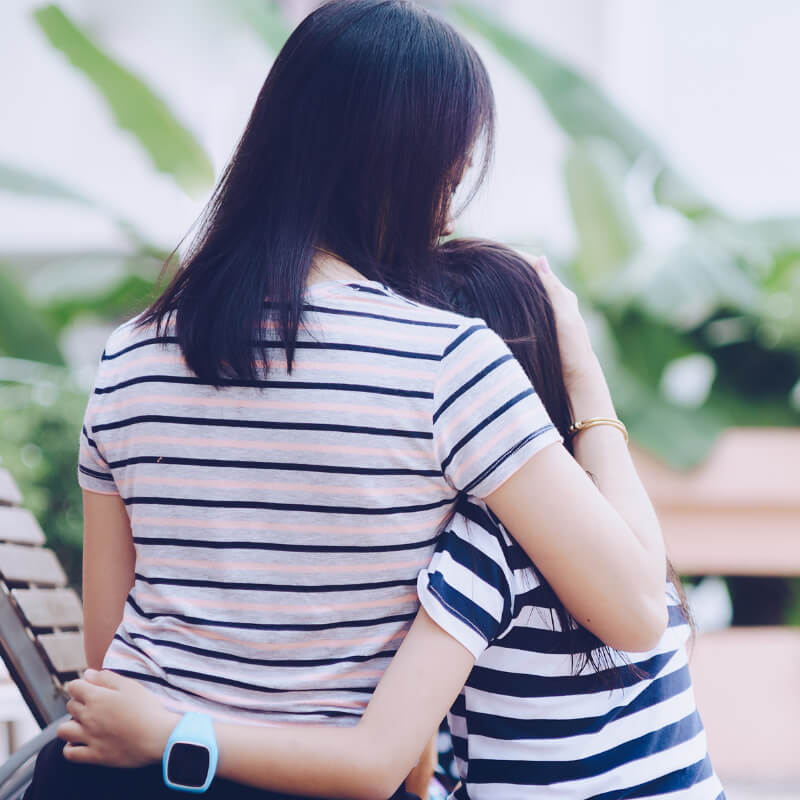 mother hugging upset daughter