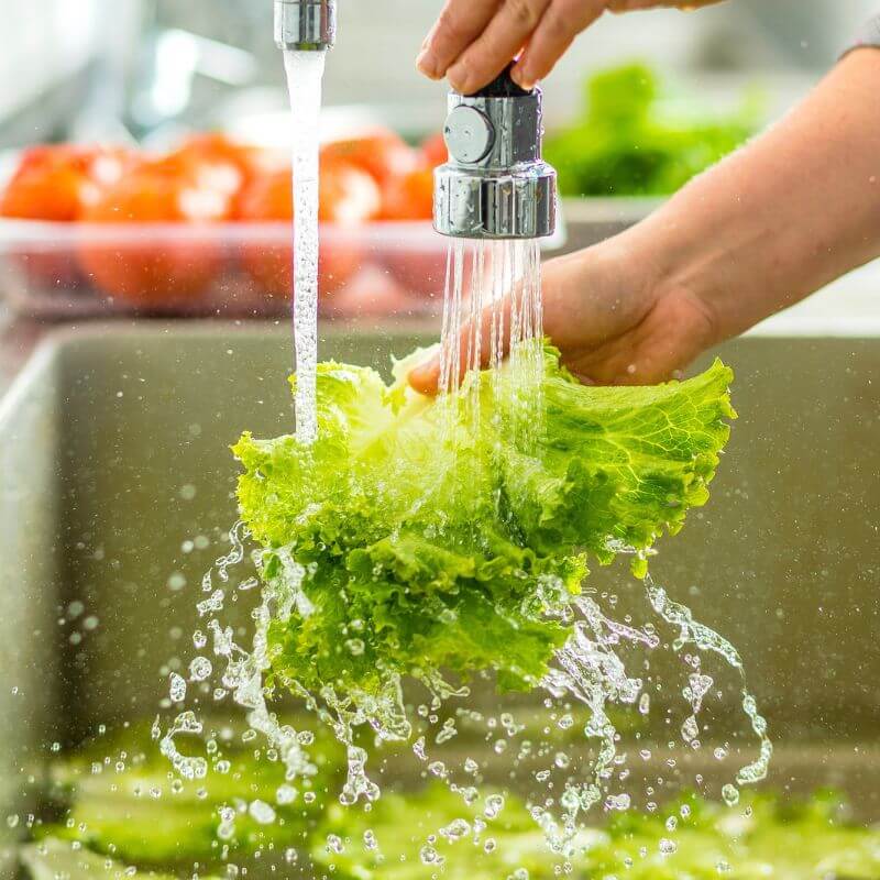 man washing salad