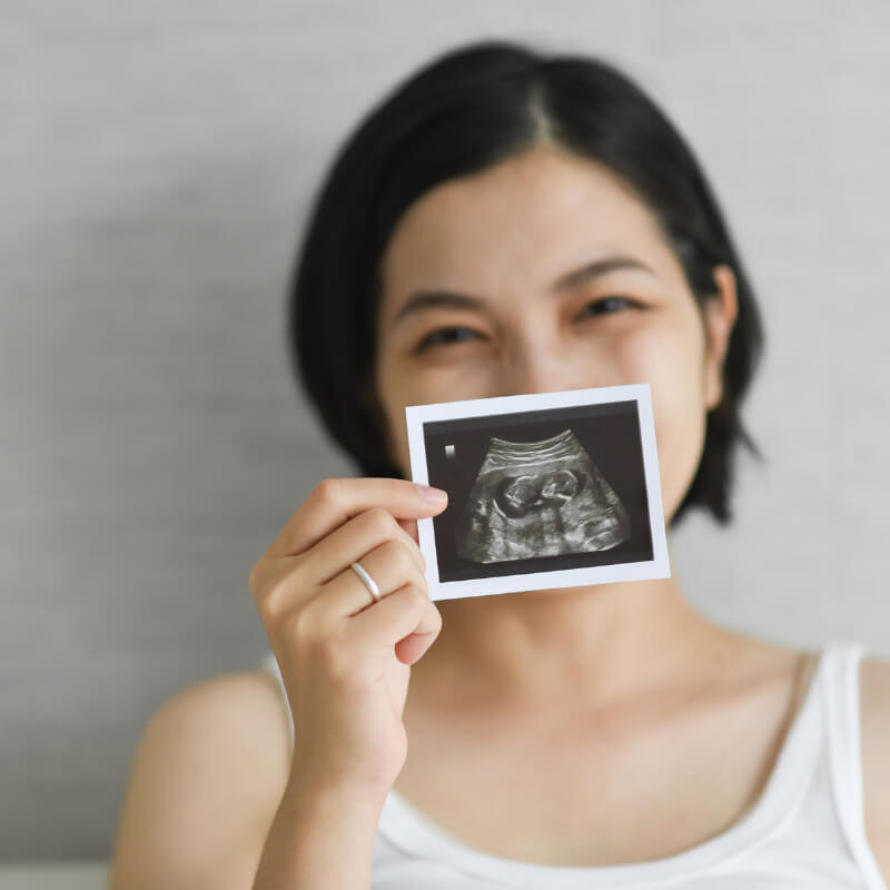 A mom happily holding scan