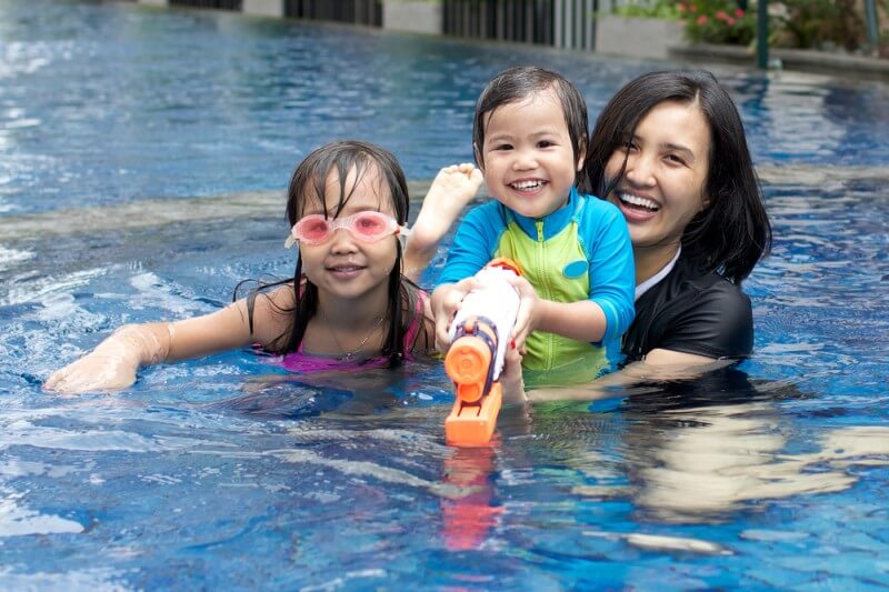 mother in pool with kids