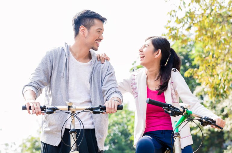 couple cycling caring for health