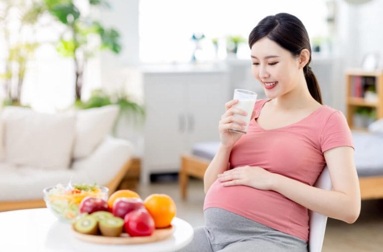 A pregnant mum drinking milk