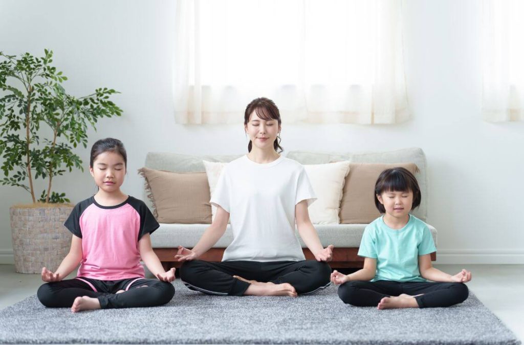 mum and kids doing yoga