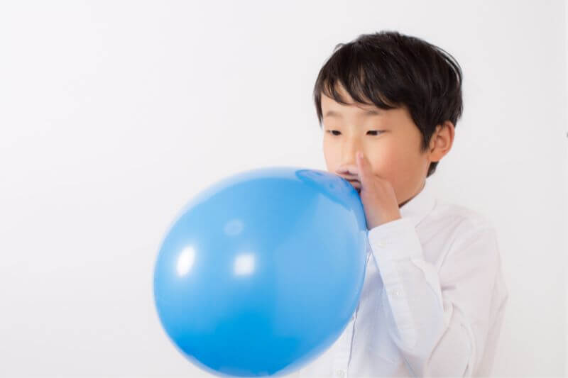 boy-blowing-balloon